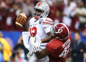 NEW ORLEANS, LA - JANUARY 01:  Cardale Jones #12 of the Ohio State Buckeyes in action against Xzavier Dickson #47 of the Alabama Crimson Tide during the All State Sugar Bowl at the Mercedes-Benz Superdome on January 1, 2015 in New Orleans, Louisiana.  (Photo by Streeter Lecka/Getty Images)