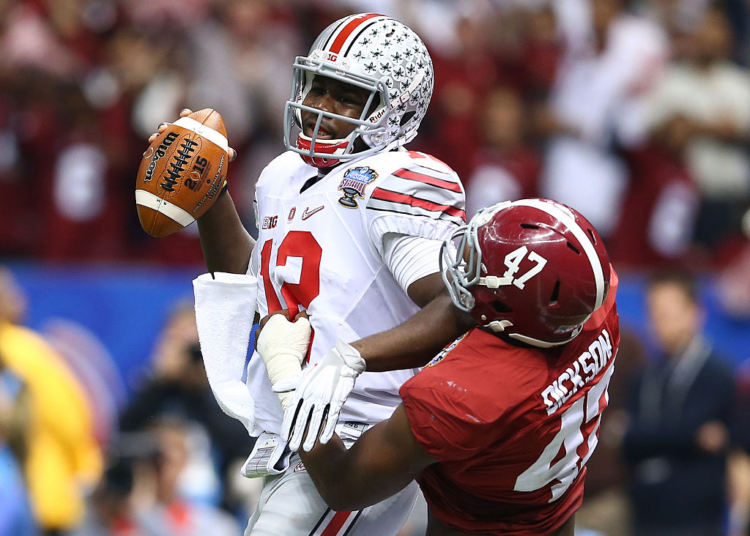 NEW ORLEANS, LA - JANUARY 01:  Cardale Jones #12 of the Ohio State Buckeyes in action against Xzavier Dickson #47 of the Alabama Crimson Tide during the All State Sugar Bowl at the Mercedes-Benz Superdome on January 1, 2015 in New Orleans, Louisiana.  (Photo by Streeter Lecka/Getty Images)